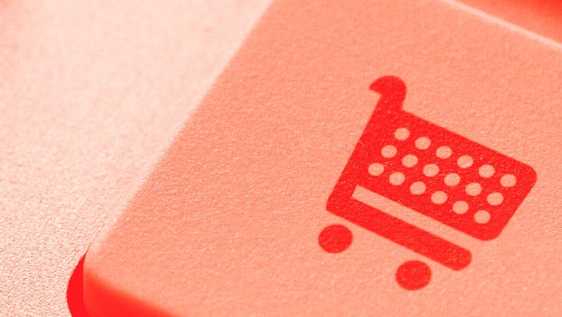 Tecla roja con icono de carrito de compras; simboliza acción de comprar online, resaltando el comercio electrónico en entorno digital.