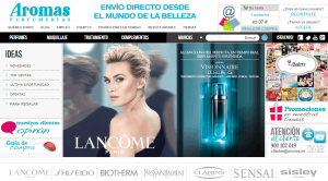 Perfumería Aromas promociona productos de belleza. Imagen de mujer y producto Lancôme. Menú con opciones, promociones y atención al cliente visible.