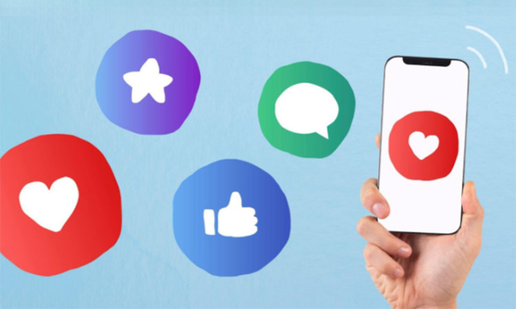Mano sostiene un smartphone mostrando un corazón rojo; alrededor, botones coloridos representan estrella, chat y "me gusta". Fondo azul claro. Marketing digital.