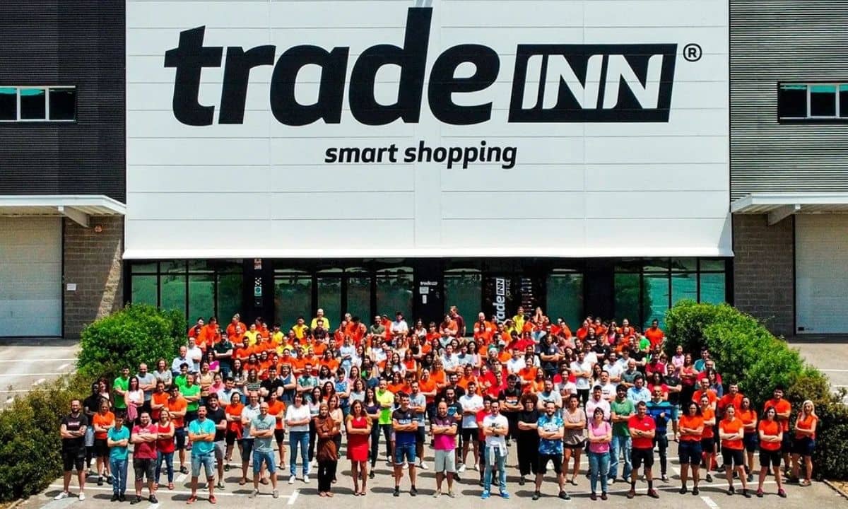 equipo de tradeinn posando ante la nave de la empresa